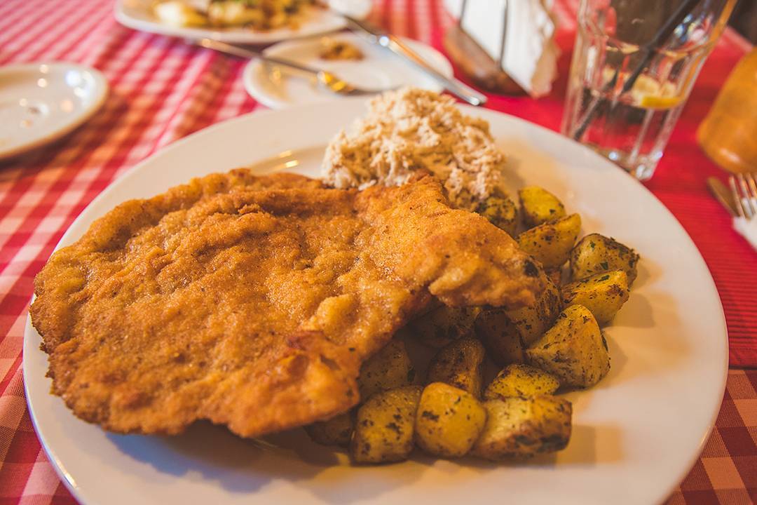 After arriving at our Airbnb in Krakow (the top floor of a beautifully renovated building with remote-controlled shades over the skylights for $60/night!), we obviously immediately went to eat. Luckily, one of the three Warsztat cafes was right across the street from us, with huge portions of traditional Polish food. I got my first of, like, ten kotlet schabowy, which is a huge pork cutlet that's been pounded flat, breaded, and fried. Mine came with fried potatoes and apple slaw, and of course I also got pierogies, so when I had ten pounds of leftovers, the restaurant put them in plastic containers and vacuum sealed them for freshness. What?! Poland is amazing.