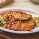 In Zakopane, we ate lunch outside on the patio at Karczma Bacówka along Krupówki, the famous promenade in the center of town. We had bacon-wrapped dates, sauerkraut soup, pierogies, and these placki ziemniaczane (potato pancakes) covered in goulash and cheese.