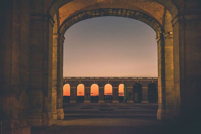 Sunset between the arches of the Royal Palace of Madrid.